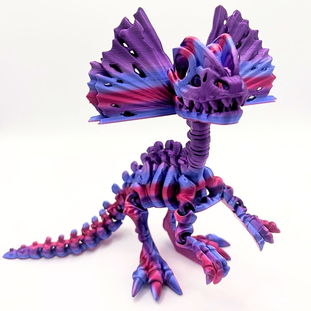 A 3D-printed articulated dinosaur skeleton toy in a vibrant purple and pink gradient, shown on a clean white background.