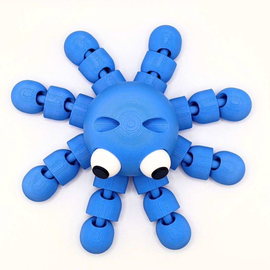 A blue octopus-shaped fidget with eight articulated arms, large white eyes, and black pupils, photographed on a clean white background.